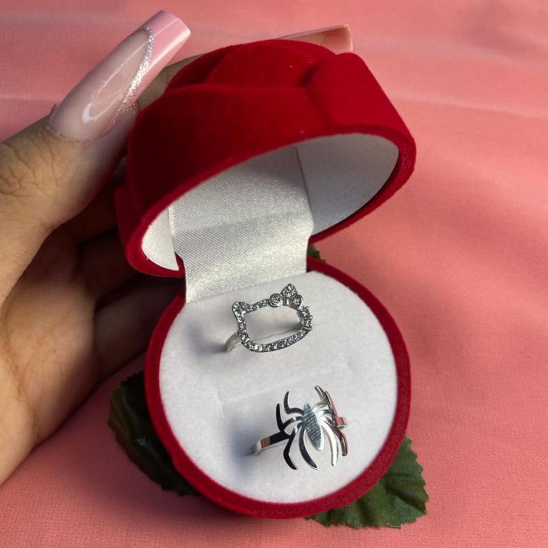 Hand holding an open red rose box with Hello Kitty and Spiderman rings - Beads by Nia
