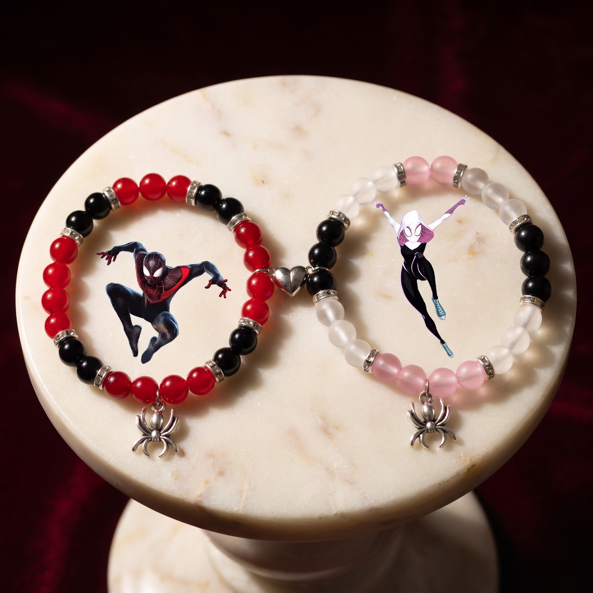 Miles and Gwen Spider-Verse bracelets displayed on a marble stand - Beads by Nia