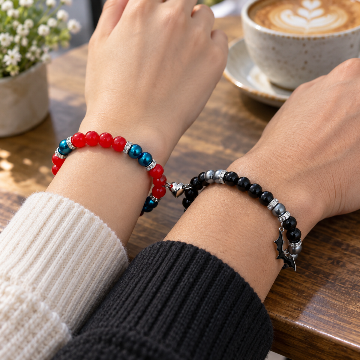Couple wearing Batman and Spiderman matching bracelets at a cafe table - Beads by Nia