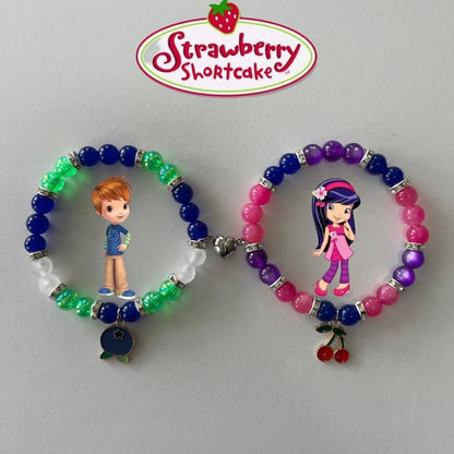 Green and purple Huckleberry and Cherry Jam bracelets with cherry and berry charms