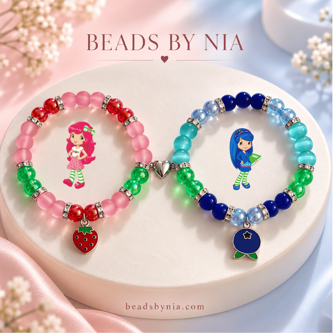Strawberry Shortcake and Blueberry Muffin beaded bracelets on a cream podium - Beads by Nia