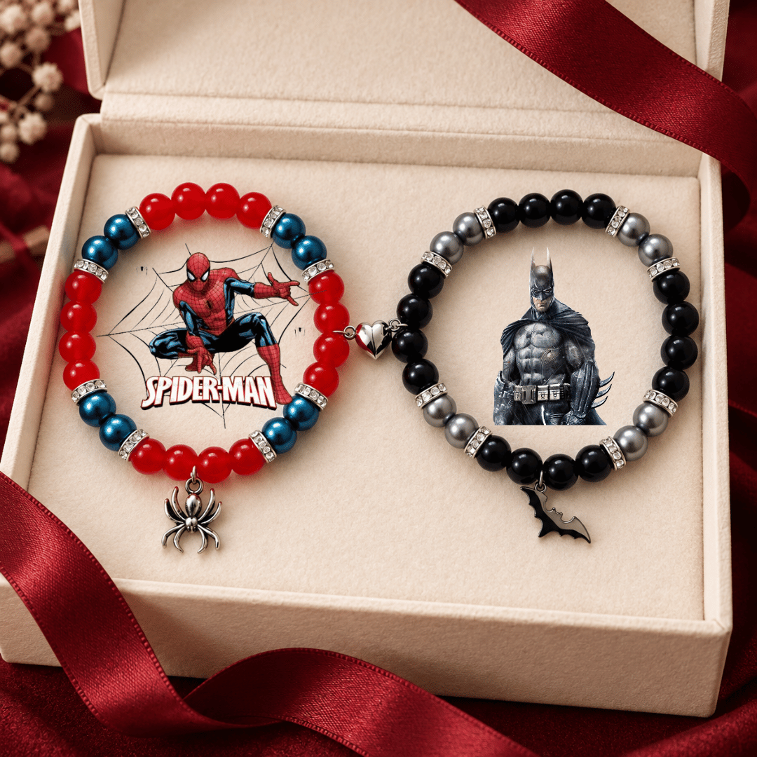 Spiderman and Batman matching bracelets in a cream gift box with red ribbon
