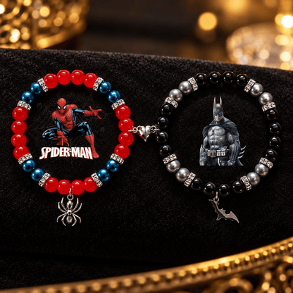 Spiderman and Batman beaded bracelets on black velvet with spider and bat charms