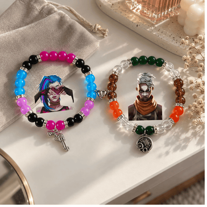Jinx and Ekko Arcane matching bracelets displayed with gold decor - Beads by Nia
