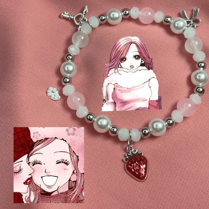 Hachi pink pearl bracelet with anime art and a red strawberry charm on pink silk