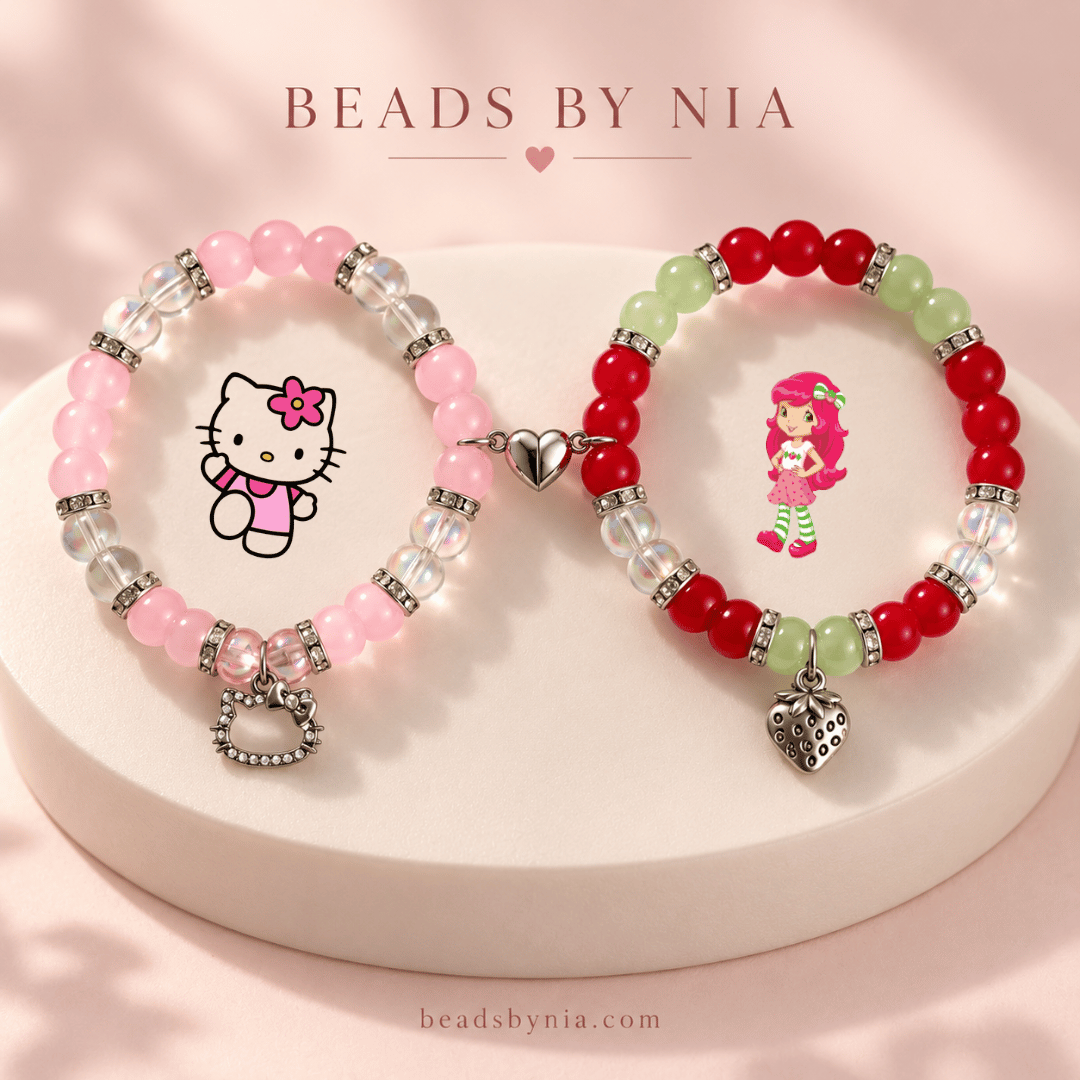 Hello Kitty and Strawberry Shortcake beaded bracelets on a cream podium - Beads by Nia
