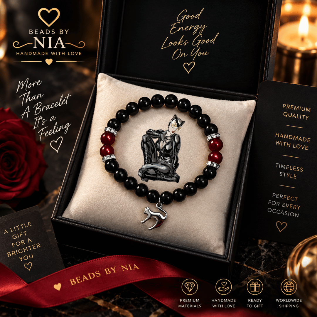 Wrist wearing the black Catwoman beaded bracelet with a silver cat charm