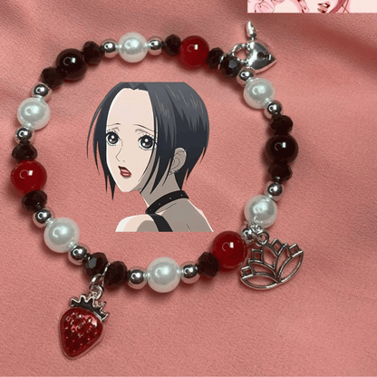 Nana red and black pearl bracelet with anime art and a strawberry charm on pink silk