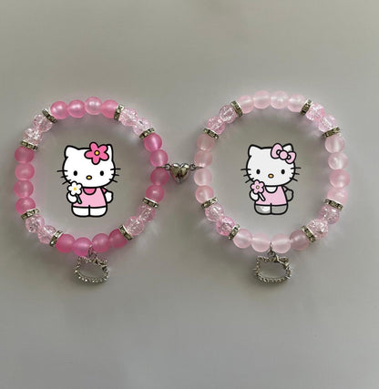 Two pink Hello Kitty beaded bracelets with character art and silver charms - Beads by Nia